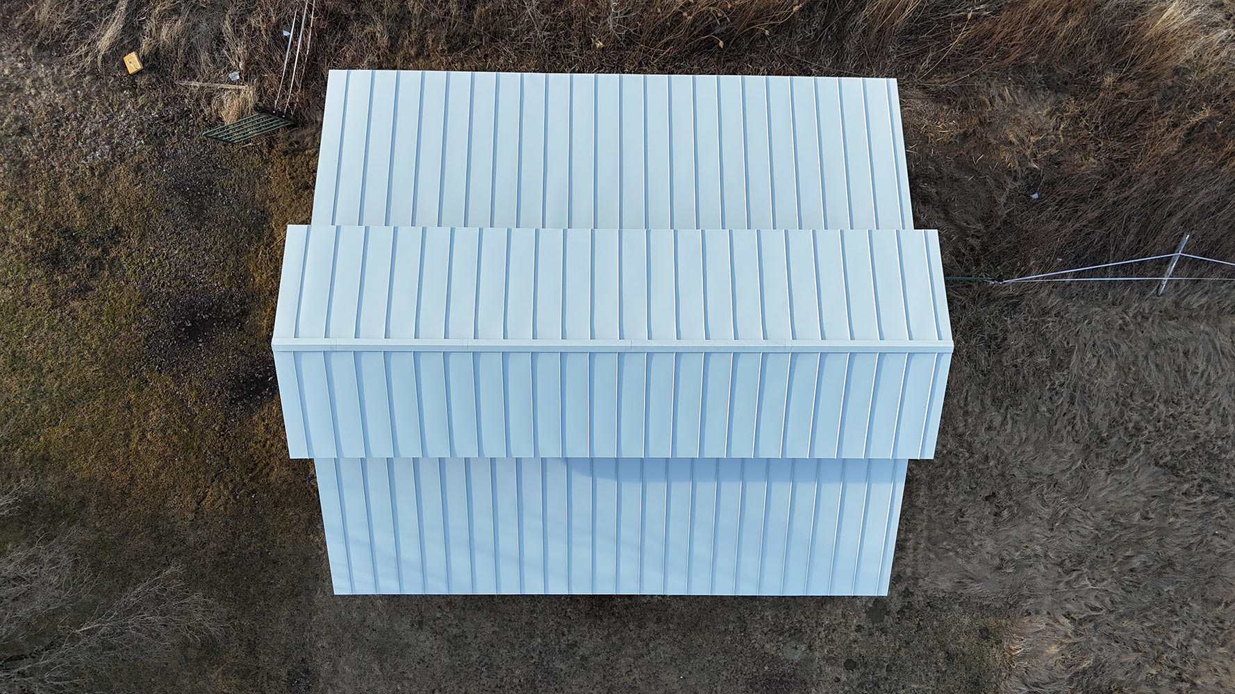 24-gauge Englert white standing seam metal barn roof Essex Vermont — overhead drone view