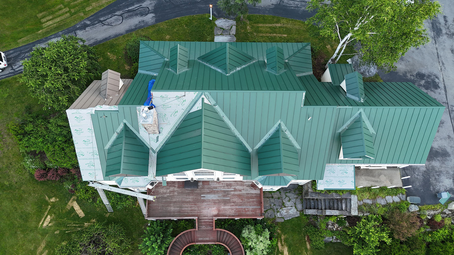 Englert standing seam metal roof replacement Waterbury Vermont luxury estate completed overhead aerial