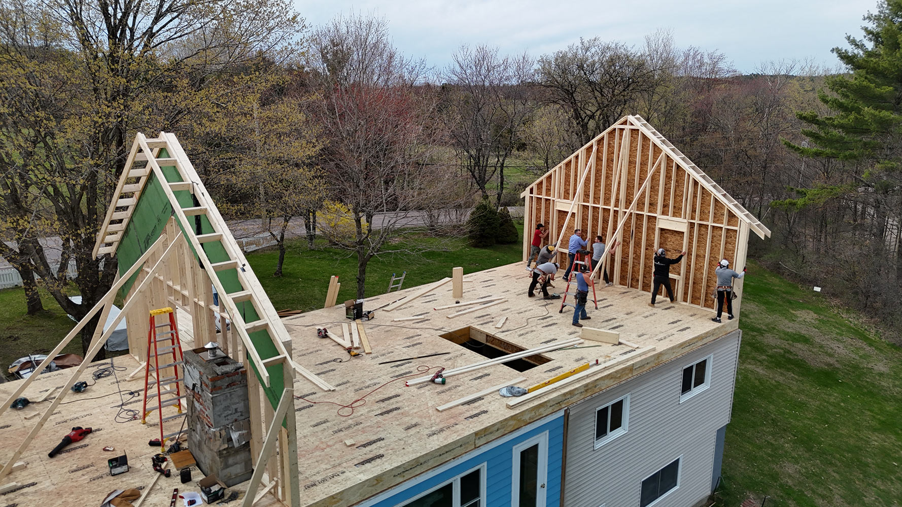 Framing crew raising gable wall second story addition Williston Vermont