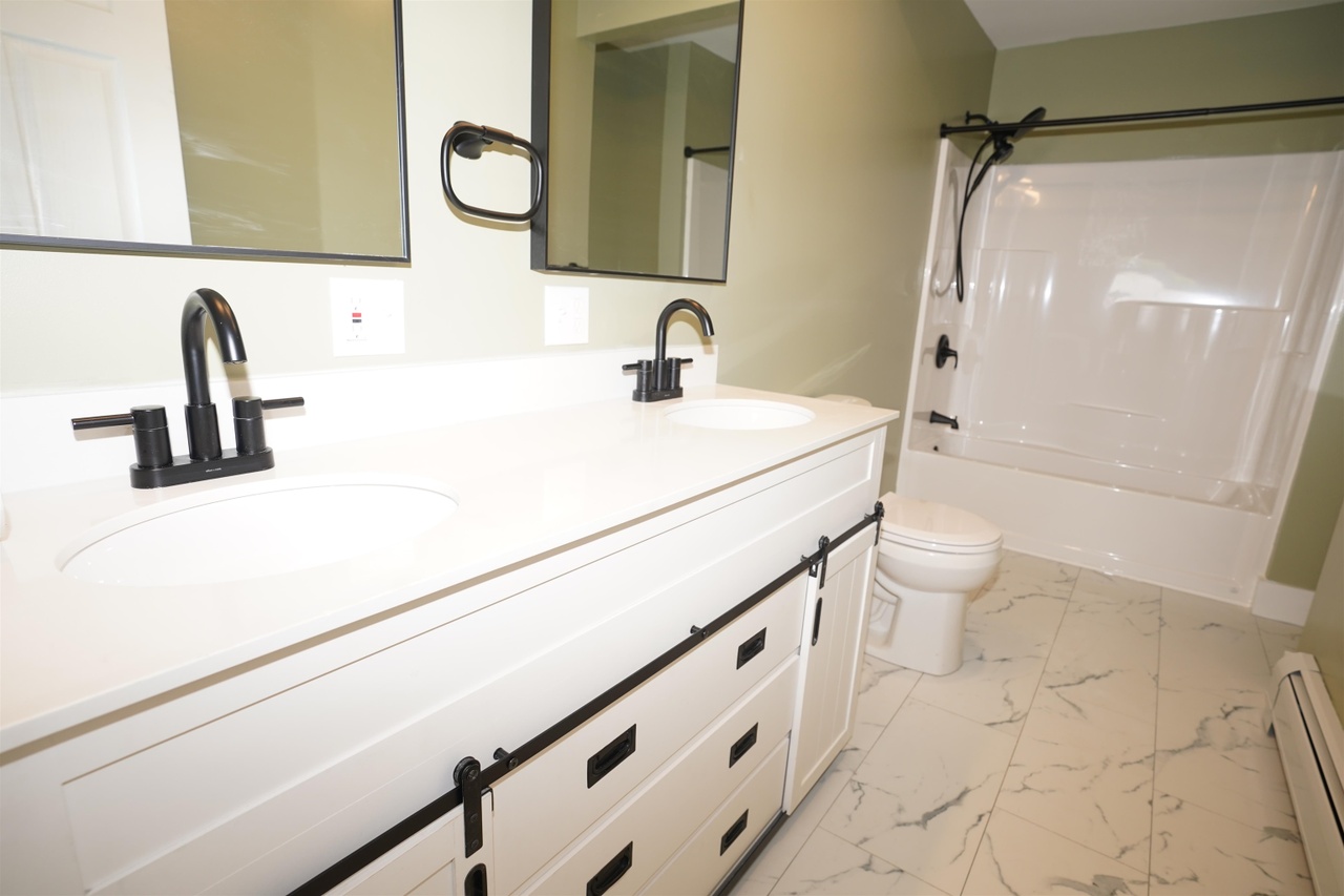Home renovation bathroom double vanity matte black fixtures Vermont