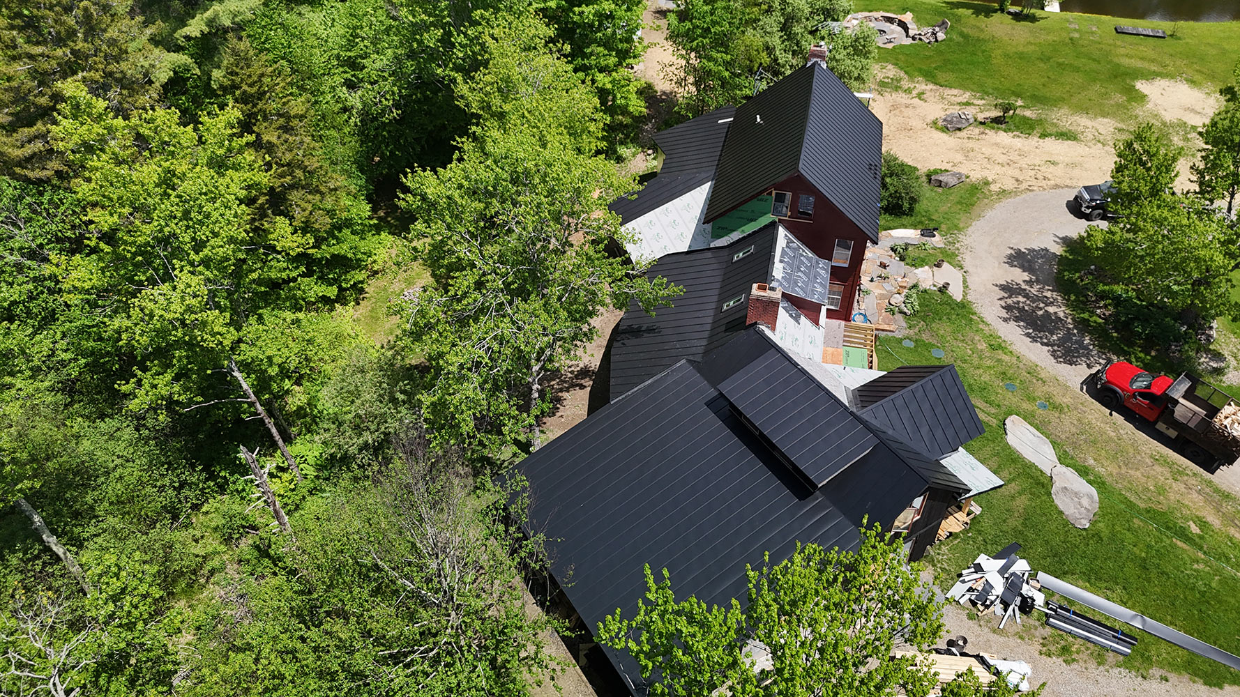 Matte black standing seam roof installation Lincoln Vermont aerial
