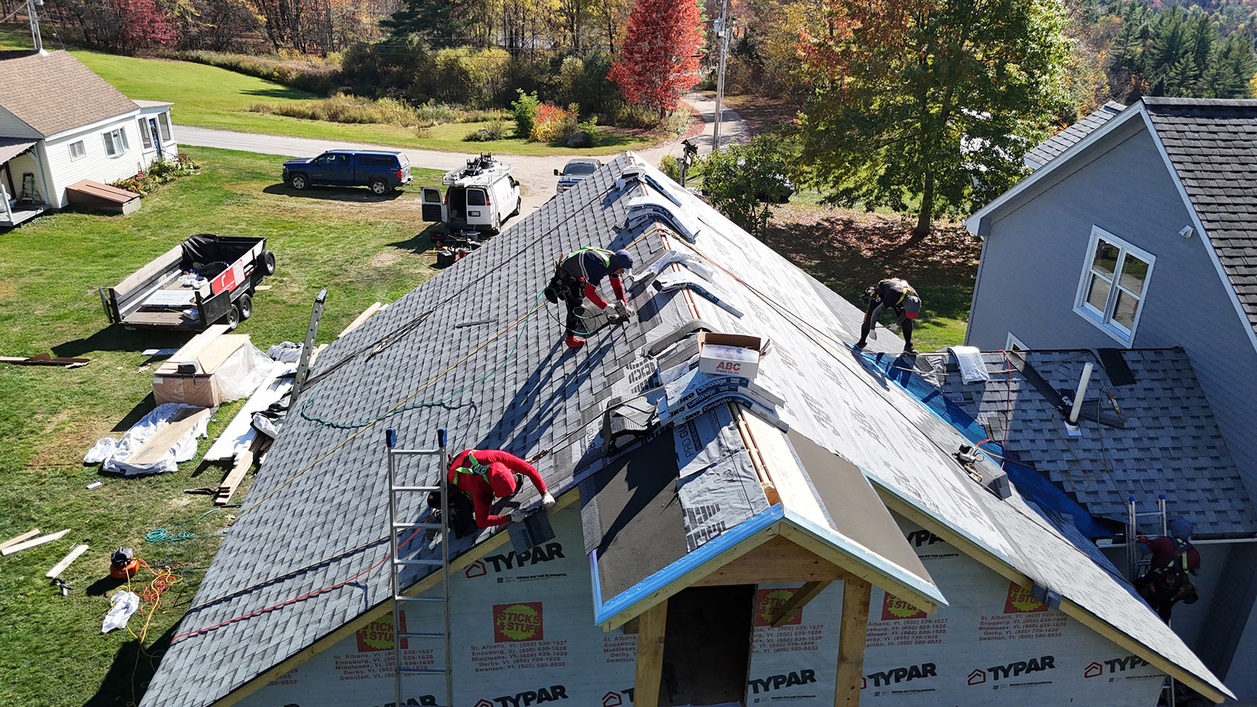 Aerial view of new garage addition framing under construction adjacent to existing home in Stowe Vermont