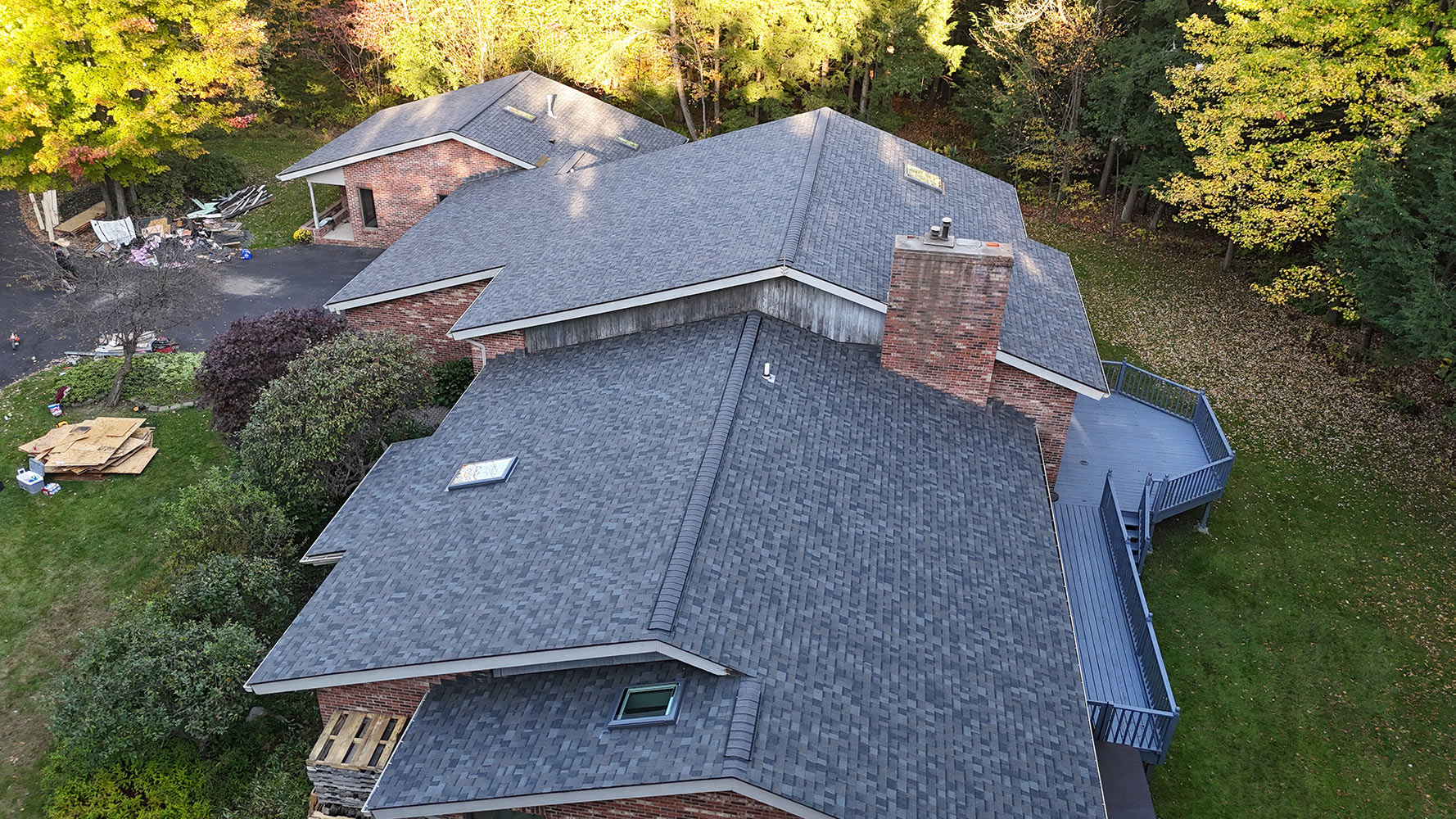 Completed full roof replacement aerial — large brick home in Williston Vermont