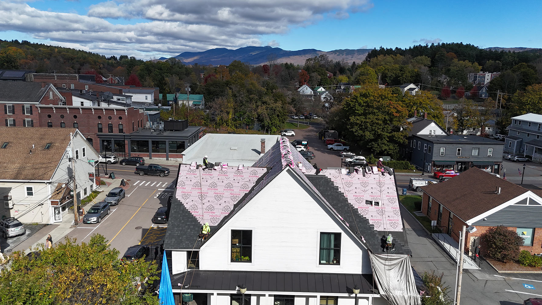 Owens Corning shingle installation Vermont village aerial with Green Mountains