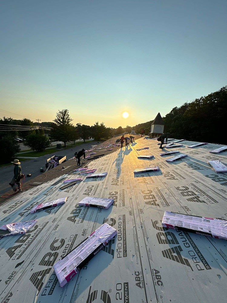 Shingle roof installation Vermont pavilion sunrise crew working