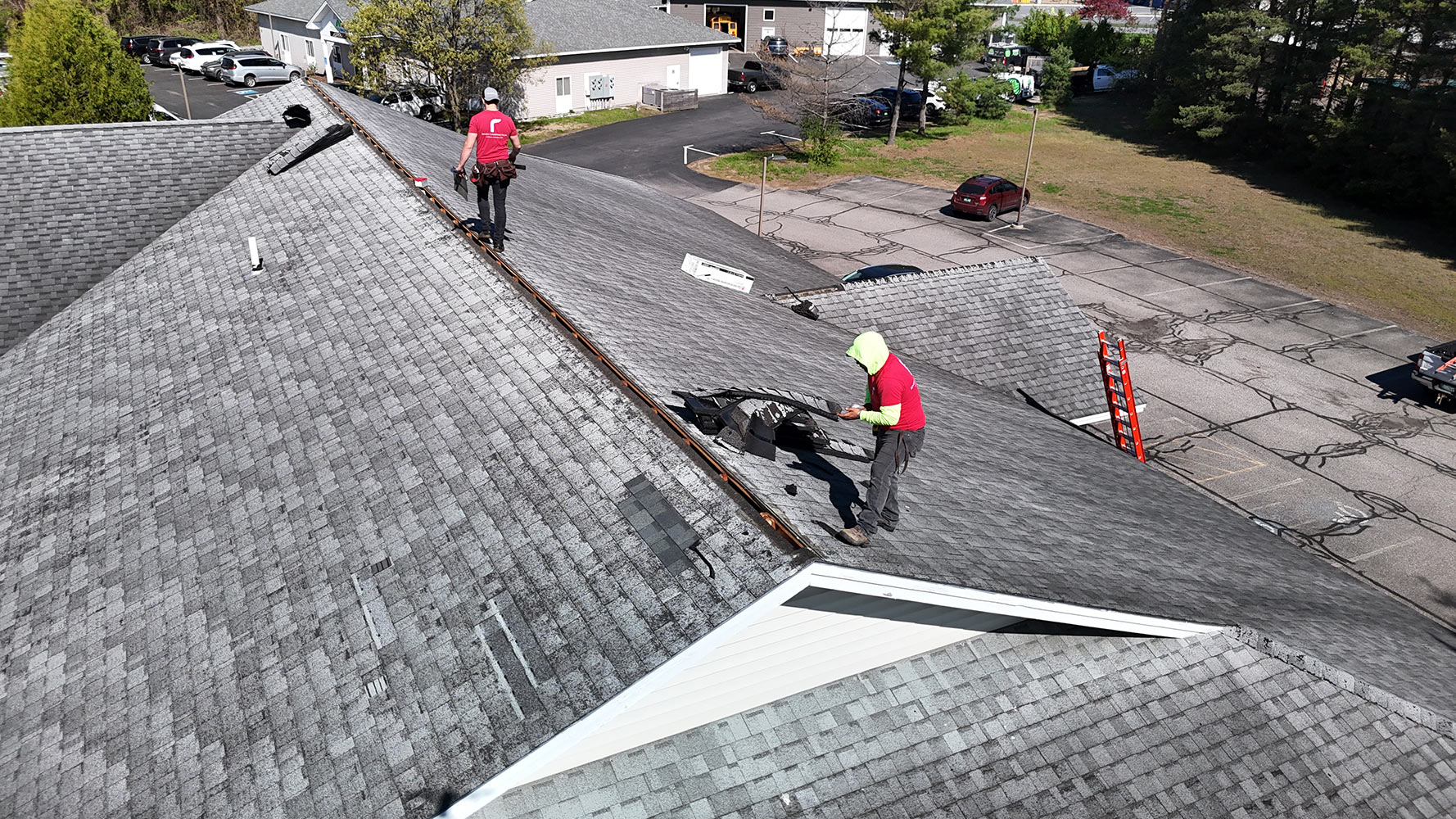 Commercial roof repair Essex Vermont — Rivers Construction crew with Owens Corning ridge cap materials on large commercial building