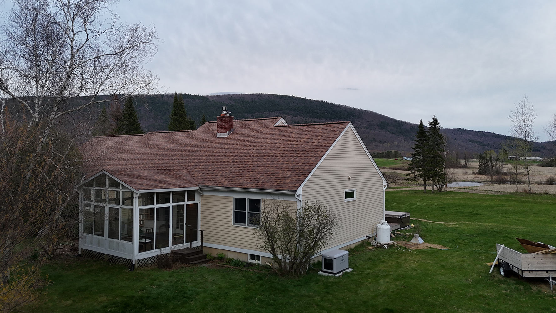 Completed shingle roof replacement Lincoln Vermont mountain view dusk