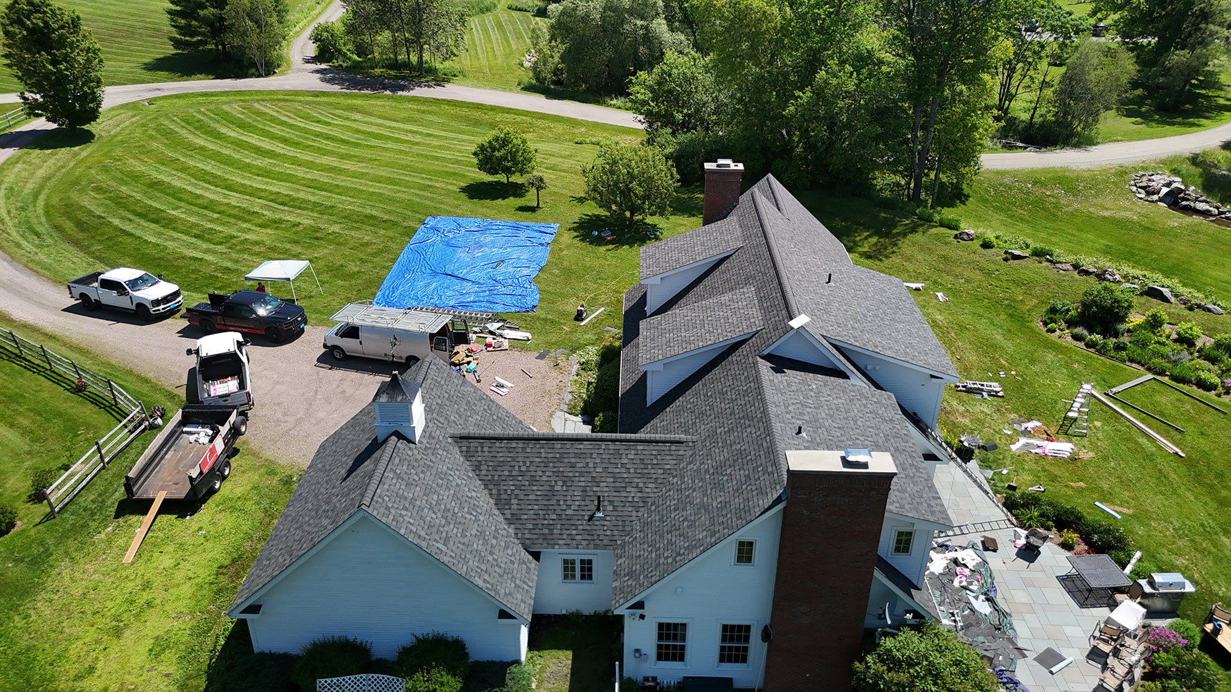 Completed shingle roof with Rivers Construction crew fleet Stowe Vermont aerial