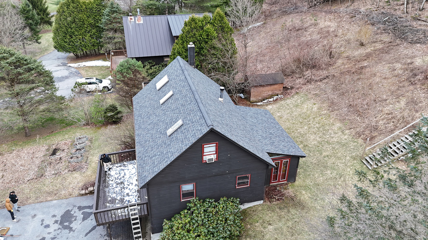 Completed shingle roof replacement aerial — Richmond Vermont home with gray architectural shingles and skylights