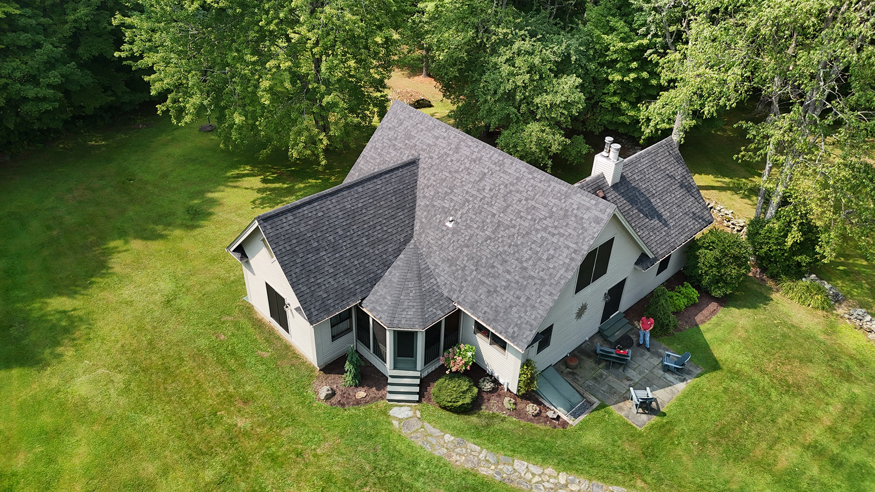 Shingle roof replacement Vermont country home Stowe — dark charcoal shingles complex roofline