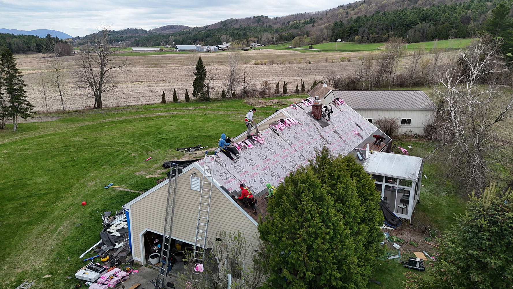 Crew tear-off shingle roof Lincoln Vermont farmland aerial