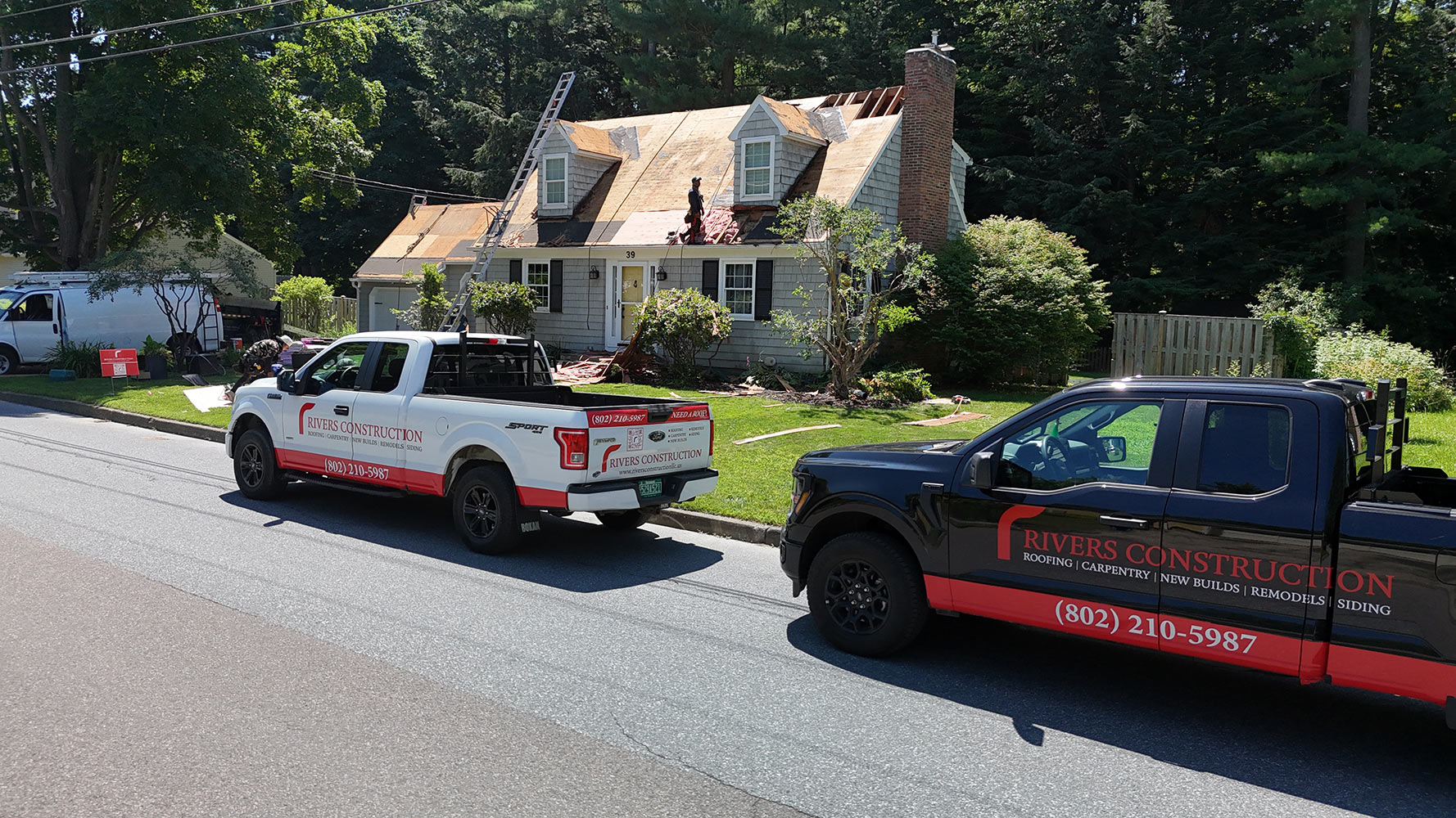 Rivers Construction crew and trucks at roof tear-off South Burlington Vermont